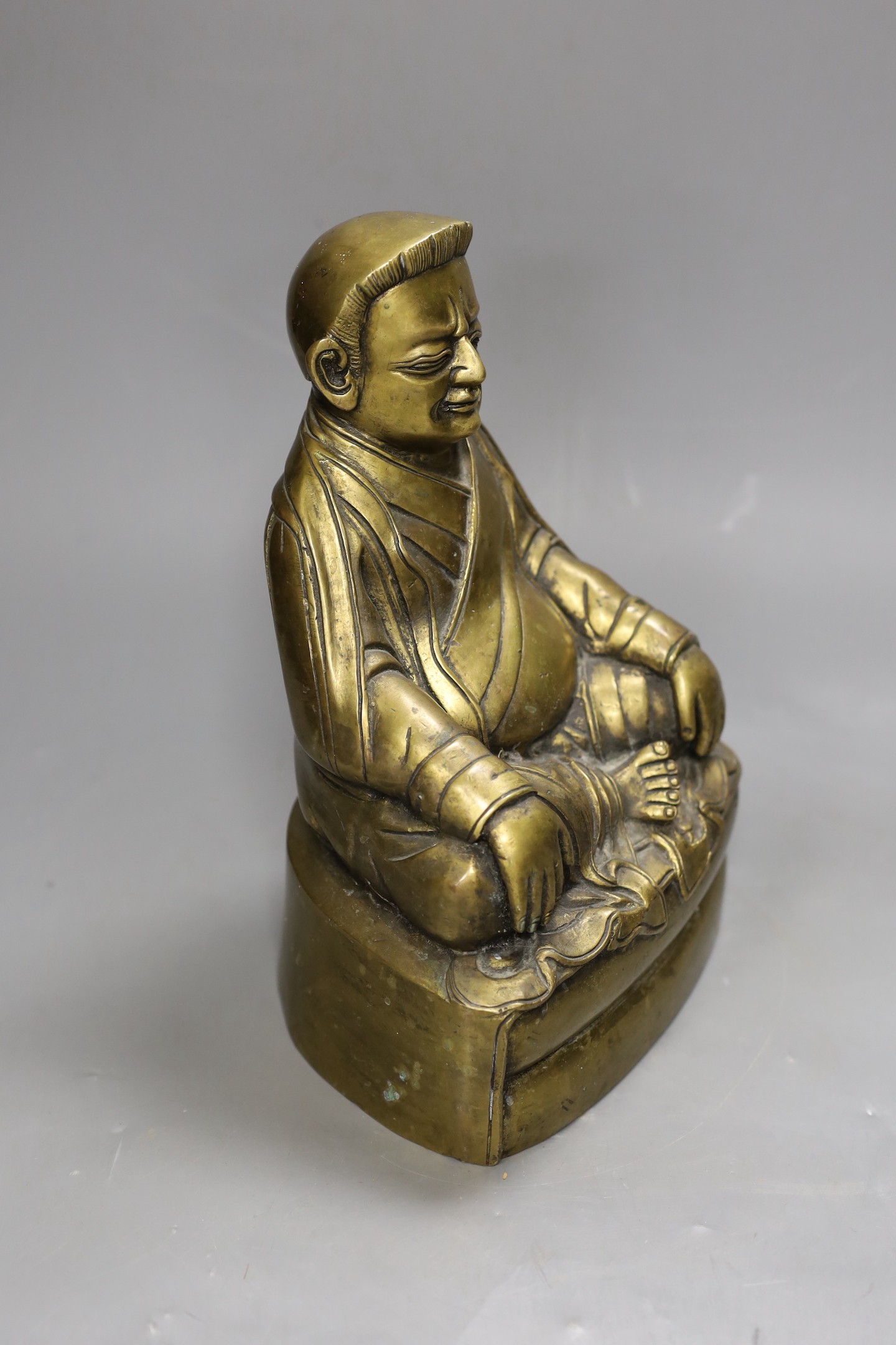 A Chinese bronze of a seated Marpa, 25cms high